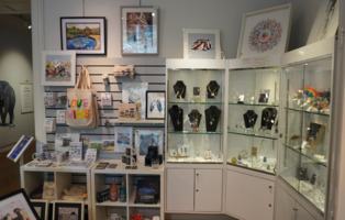 The gift shop at The Cooper Gallery, with several items on display, such as artwork, bags and necklaces