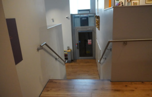 A set of steps leading down to the lift at The Cooper Gallery